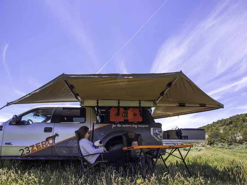 Family camping in shade of peregrine 270 awning
