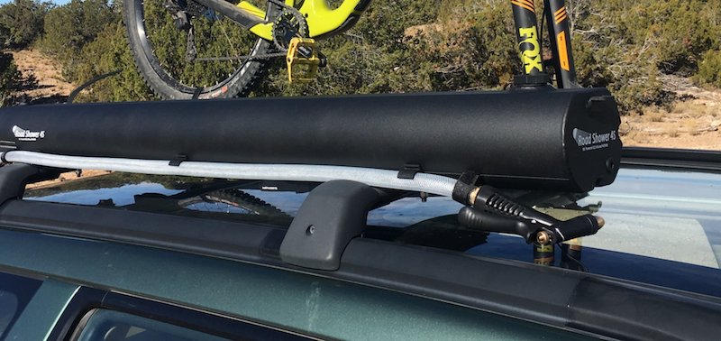 Road Shower 4S portable camping shower mounted on roof rack with mountain bike for adventure travel portable water needs
