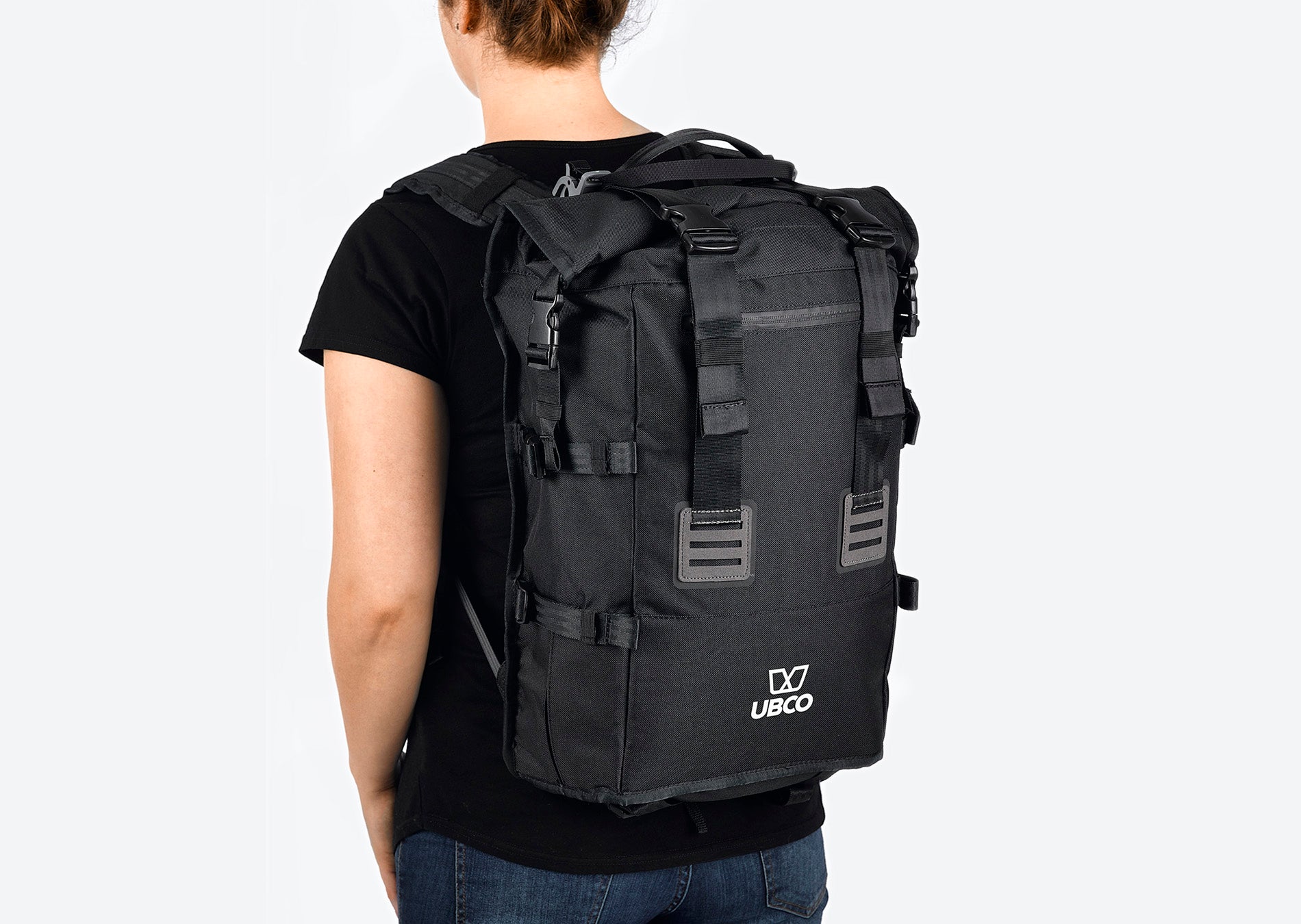 Black Pannier Backpack for Ubco 2x2 Electric Adventure Bike. Backpack is being modeled on a person's back