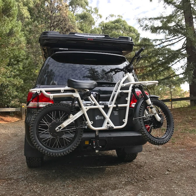 Rear view of Toyota Landcruiser with Ubco Towball Mount Bike Rack for transporting 2x2 electric motorbike
