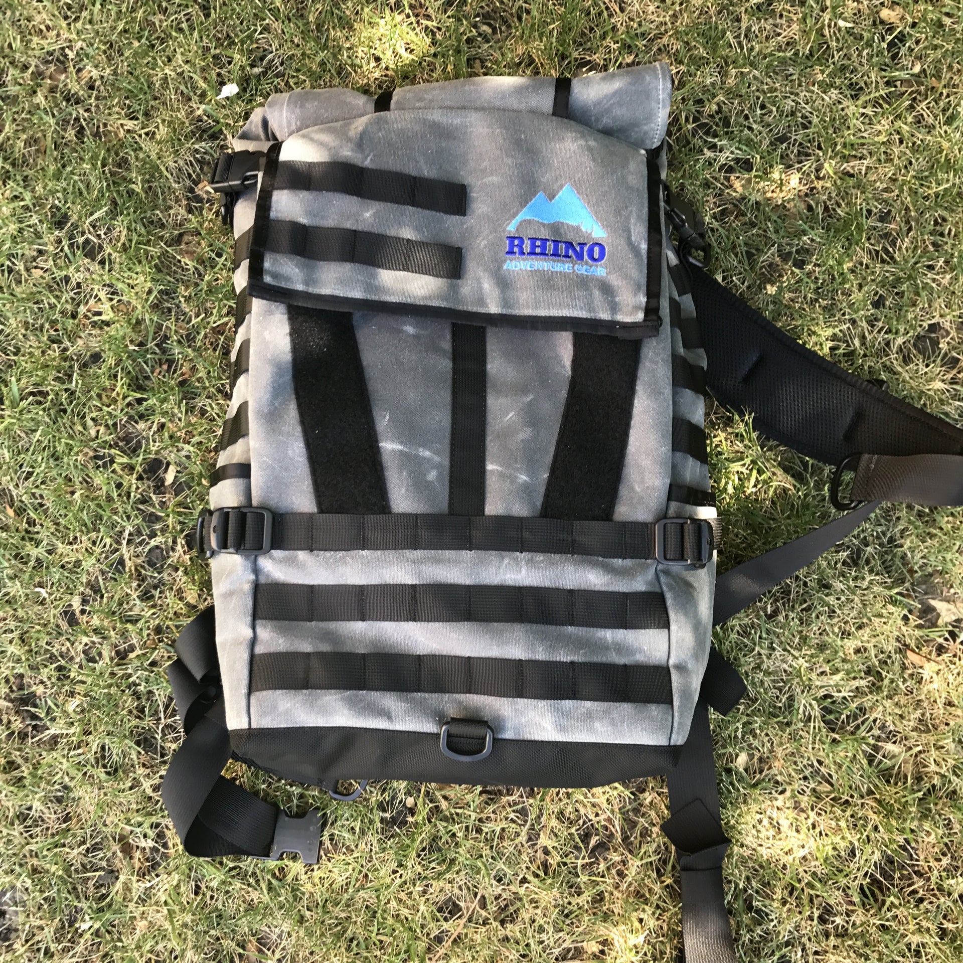 Adventure Backpack with Rhino Adventure Gear embroidered logo laying on the grass