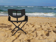 Front Runner Expander Chair all black camping chair shown set up in sand at the beach