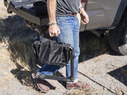 Front Runner Expander Chair all black camping chair shown being carried using build in handle