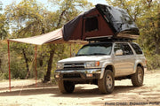iKamper Skycamp Roof top tent with Awning attachment on top of white Toyota