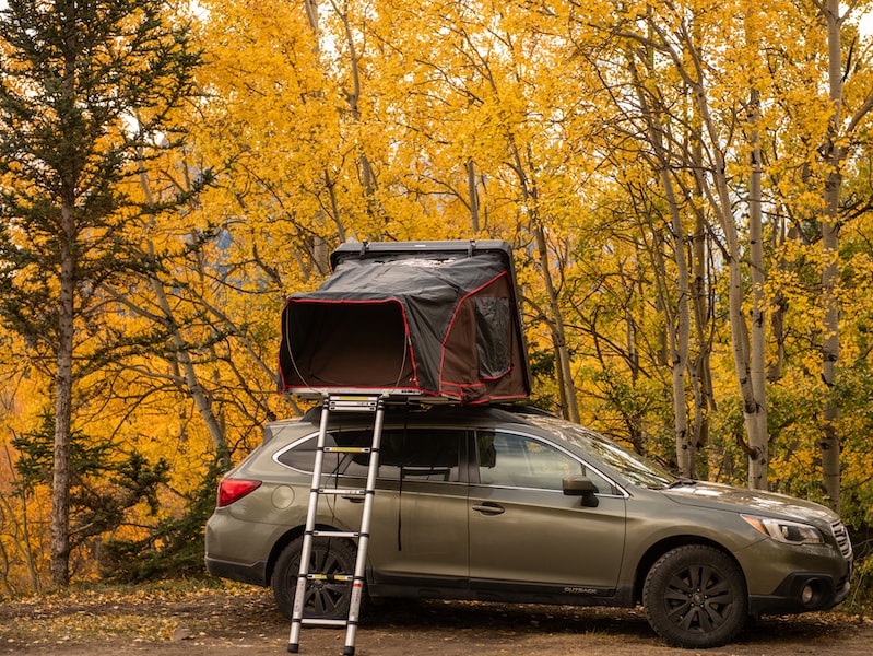 Explosively vibrant inflatable roof tent makes small car a mini-camper