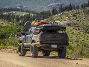 iKamper Skycamp Mini Roof Top Tent shown mounted on Tacoma bed rack - closed