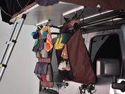 iKamper Skycamp roof top tent shoe rack attached to bottom of roof top tent. Shoe rack hangs from the underside of the tent, near the ladder 