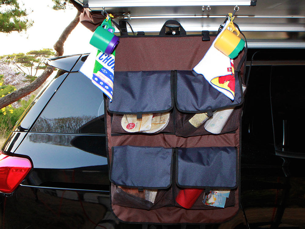 Storage shelf for iKamper Skycamp, shown hanging from the base of the roof top tent