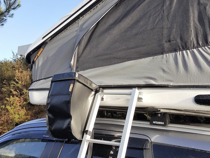 black PVC bag mounted near ladder of roof top tent