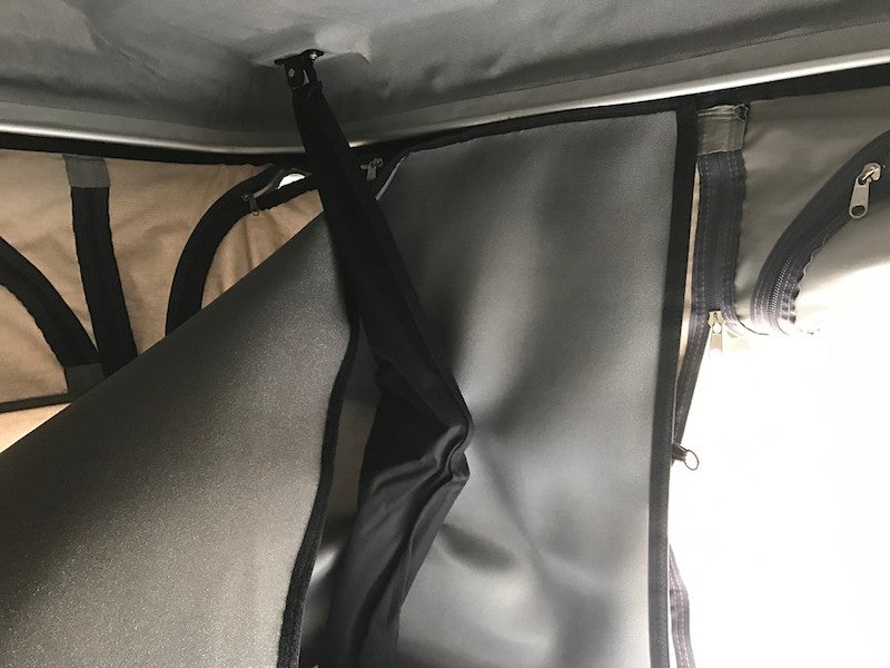 James Baroud Isothermic Kit is simple to install by attaching to velcro surrounding the ceiling of the interior of the tent. The insulating lining is shown hanging down just inside the regular roof top tent walls