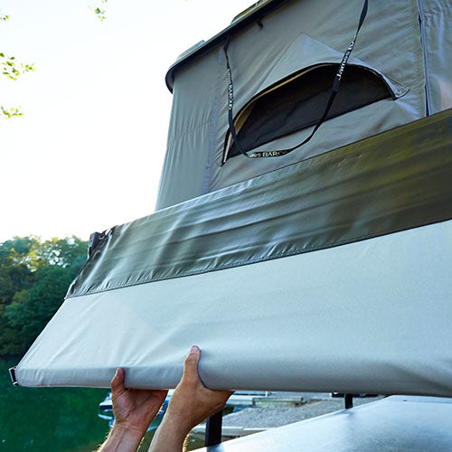 James Baroud side awning for roof top tents shown being unrolled to set up awning.