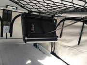 Tablet holder clipped to ceiling net in roof top tent