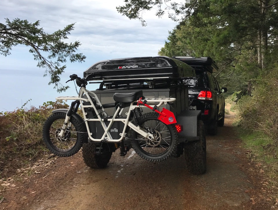 Overland vehicle and trailer with Ubco 2x2 bike rack installed on trailer hitch