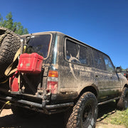 Overland vehicle with dust proof crush proof heavy duty first aid kit mounted on back of vehicle next to spare tire and trasharoo