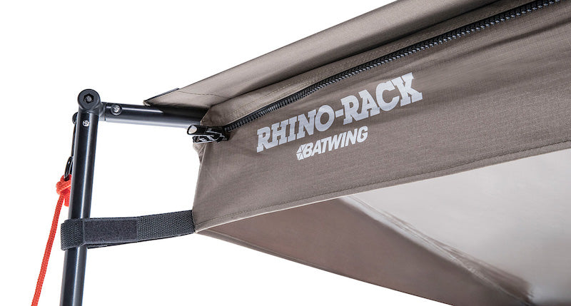 Detail of corner of Rhino Rack Batwing Awning with poles and guy lines set up