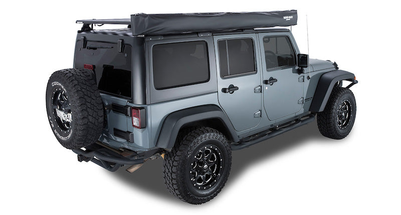 Batwing Awning mounted on passenger side of Jeep, shown packed up in black cover bag