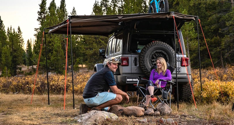 Rhino-Rack Batwing Compact Awning- on Jeep at campsite