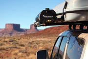 Road shower 4 mounted alongside roof top tent on roof rack with scenic western landscape in background