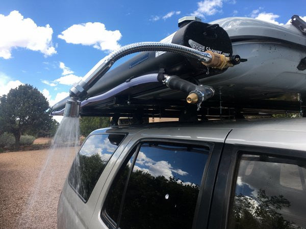 Road Shower roof rack mounted shower shown with shower nozzle spraying water