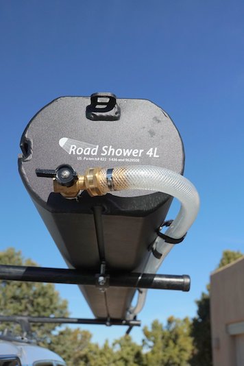 Road Shower 4L portable camping shower shown mounted on roof rack