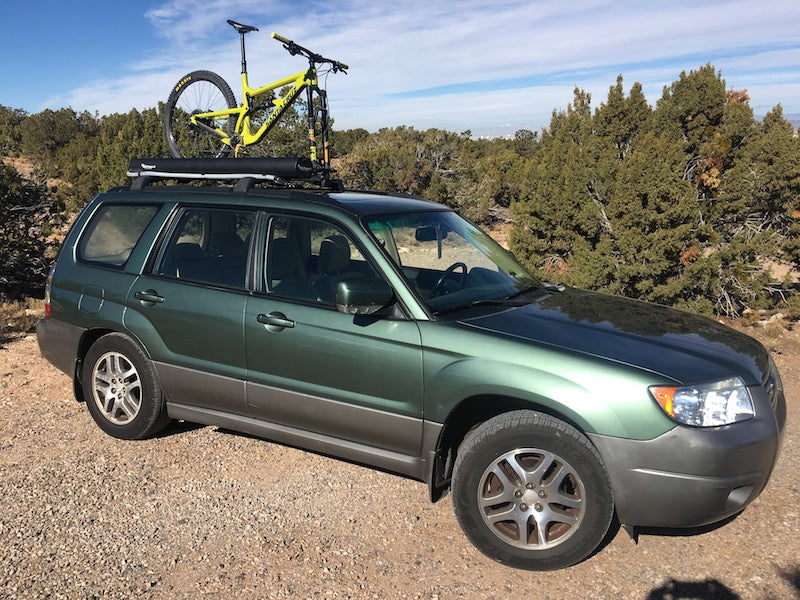 Off road subaru equipped with Road Shower 4S shower on vehicle roof rack
