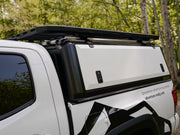Side view of Toyota Tacoma truck cap by RLD Designs shown with optional platform rack system added