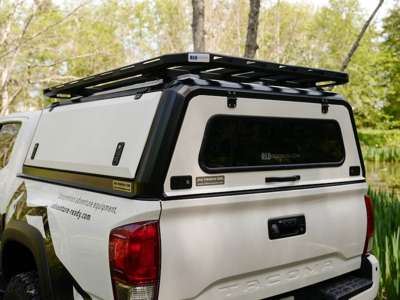 RLD Design stainless Steel Canopy for 3rd Gen Toyota Tacoma shown with white doors