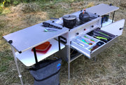 Trail Kitchens Camp Kitchen with Integrated Stove set up outdoors with utensil drawer open and pots on the stove