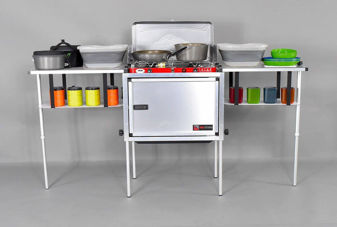 Trail Kitchens Camp Kitchen shown assembled with cookware and dinnerware on shelves