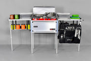 Trail Kitchens Compact Camp Kitchen assembled with camping cookware and dinnerware stowed on shelving