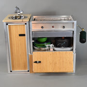 Trail Kitchens Van Kitchen bamboo skin finishing on kitchen unit shown with storage cabinet open