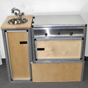 Trail Kitchens Van Kitchen modular sink and removable kitchen workstation shown with birch paneling skin and counter space cover over stovetop