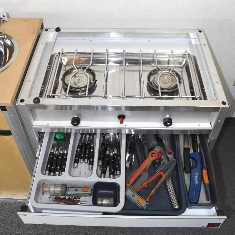 Trail Kitchens Van Kitchen slide out utensil drawer under stovetop with organizing dividers for kitchen essentials