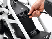 Ubco 2x2 electric utility bikes battery can be used to charge devices- hand plugging in 12V charging cable into bike's control panel