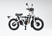 ubco 2x2 electric adventure bike shown mounted on the towball bike rack. No vehicle is shown in the image, just the bike and the bike rack demonstrating where the frame of the 2x2 bike would rest on the arms of the bike rack
