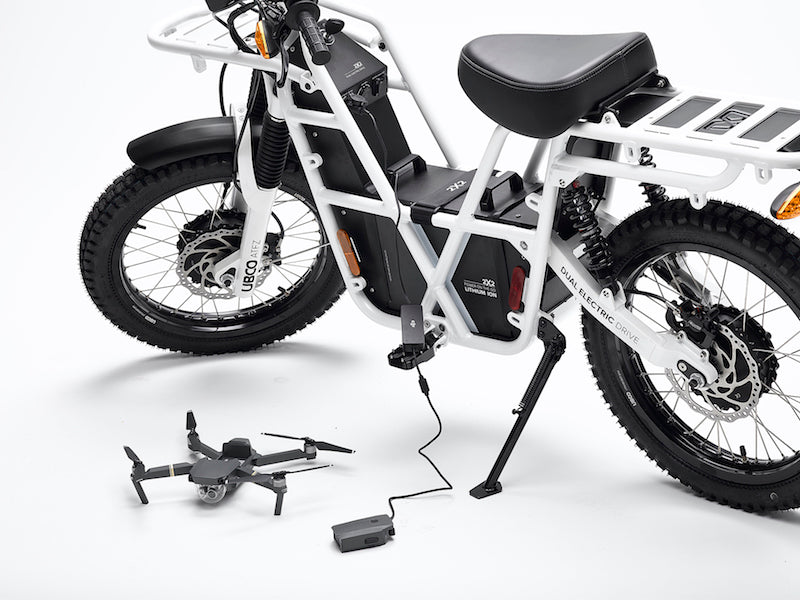 Recharging a drone using the portable battery pack equipped on Ubco 2x2 utility off road bikes