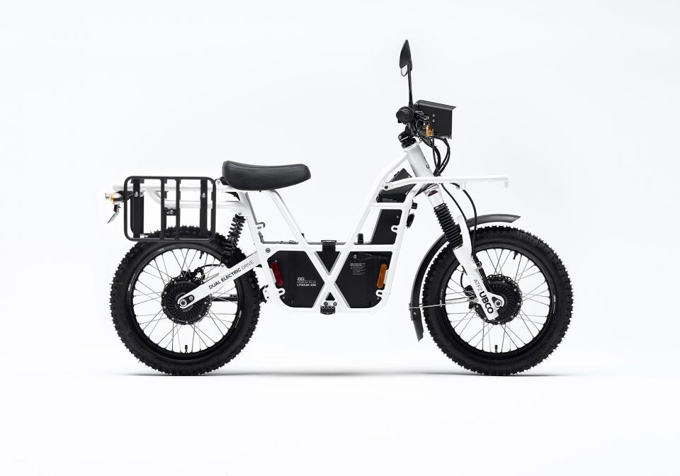 Side profile view of Ubco 2x2 electric adventure bike with pannier racks mounted on rear of bike