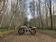 ubco 2x2 2017 off road electric adventure bike from Rhino Adventure Gear shown on dirt path in forest