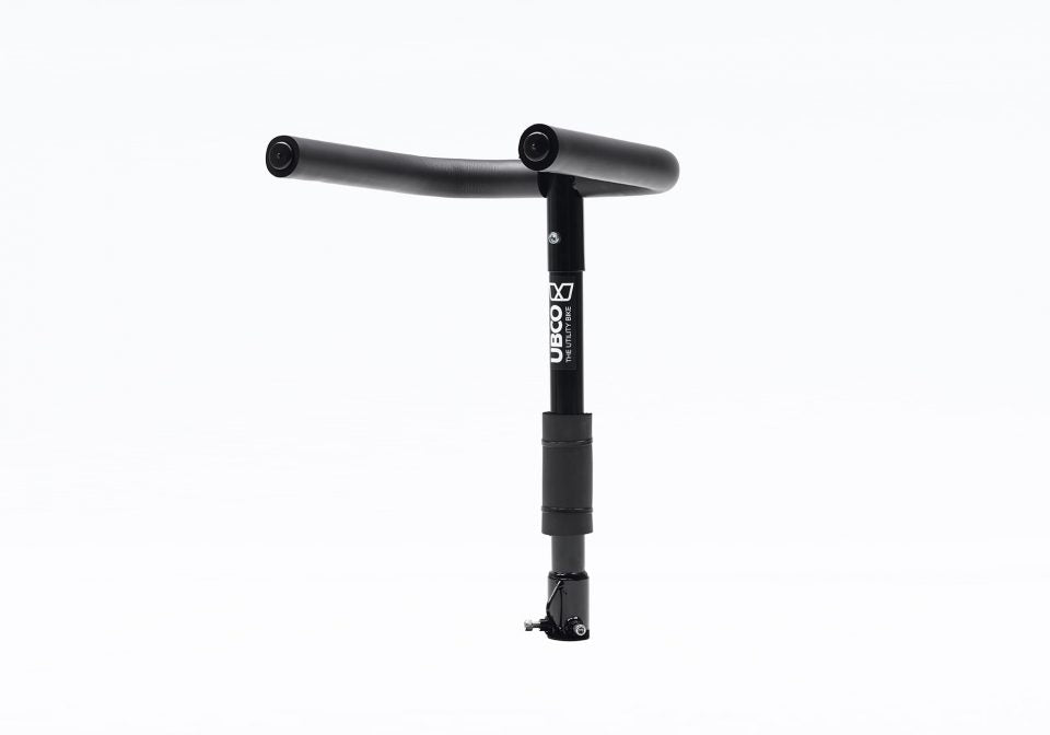 Towball mount bike rack for Ubco 2x2 electric dirt bike. Bike rack is black with two foam covered steel arms perpendicular to the vertical shaft which couples with the vehicle's towball
