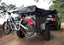 Towball mount bike rack for Ubco 2x2 electric adventure bike shown with bike loaded on rack attached to rear of off road camping trailer