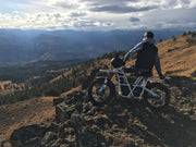 Ubco 2x2 off-road electric adventure bike available at Rhino Adventure Gear shown overlooking scenic vista